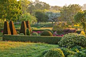 PETTIFERS, OXFORDSHIRE: THE PARTERRE IN SPRING, APRIL, EARLY MORNING, DAWN, GRASS, LAWN, CLIPPED, YEW TOPIARY, ENGLISH, COUNTRY, GARDEN