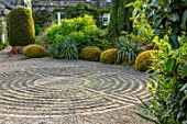 YORK GATE, YORKSHIRE: CIRCULAR PAVEMENT MAZE, STONE SETTS, GRAVEL, DRIVE, CLIPPED TOPIARY YEWS, TAXUS, YUCCAS, FRONT GARDEN, JUNE, SUMMER