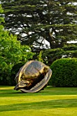 NEVILL HOLT, LEICESTERSHIRE: MARC QUINN SCULPTURE, THE ORIGIN OF THE WORLD, LAWN, HEDGES, HEDGING, CEDAR, TREE