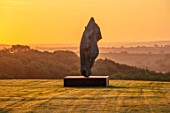 NEVILL HOLT, LEICESTERSHIRE: DAWN, SUNRISE, SCULPTURE OF HORSE HEAD BY NIC FIDDIAN GREEN, LAWN