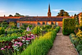 NEVILL HOLT, LEICESTERSHIRE: THE WALLED VEGETABLE GARDEN, POTAGER, PATH, LAVENDER VERA, SWEET WILLIAMS, CROCOSMIA LUCIFER, POTATOES CHARLOTTE, DELPHINIUM SUMMER SKIES