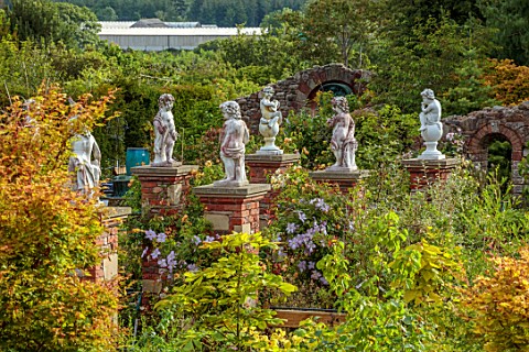 LARCH_COTTAGE_NURSERIES_CUMBRIA_VIEW_OF_NURSERY_BRICK_PILLARS_WITH_STATUES_SUMMER_JULY