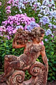 LARCH COTTAGE NURSERIES, CUMBRIA: STATUE, BORDER OF PHLOX, BORDERS, ORNAMENTS, FORMAL, PINK FLOWERS, SUMMER, GREENHOUSE