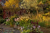 LARCH COTTAGE NURSERIES, CUMBRIA: POOL, POND, WATER, WATERLILIES, CHAPEL BUILT IN 2014 BY PETER STOTT, STORMY WEATHER, EVENING LIGHT, GARDEN, BUILDING, HOSTAS, WILLOWS