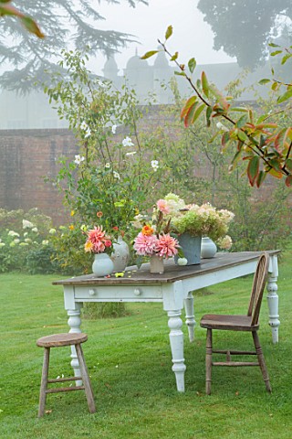 THE_FLOWER_GARDEN_AT_STOKESAY_COURT__LAWN_AMELANCHIER_TABLE_CONTAINERS_DAHLIAS_PENHILL_WATERMELON_PR