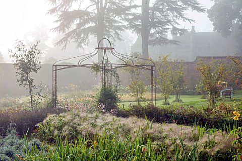 THE_FLOWER_GARDEN_AT_STOKESAY_COURT__METAL_ARBOUR_IN_THE_WALLED_GARDEN_STIPA_TENUISSIMA_PANICUM_ELAG