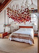 JUST DAHLIAS, CHESHIRE: BEDROOM WITH DAHLIA INSTALLATION ABOVE BED BY PHILIPPA STEWART