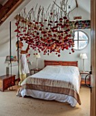 JUST DAHLIAS, CHESHIRE: BEDROOM WITH DAHLIA INSTALLATION ABOVE BED BY PHILIPPA STEWART