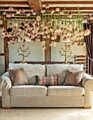 JUST DAHLIAS, CHESHIRE: LIVING ROOM WITH DAHLIA INSTALLATION ABOVE BED BY PHILIPPA STEWART