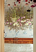 JUST DAHLIAS, CHESHIRE: BEDROOM WITH DAHLIA INSTALLATION ABOVE BED BY PHILIPPA STEWART, MIRROR