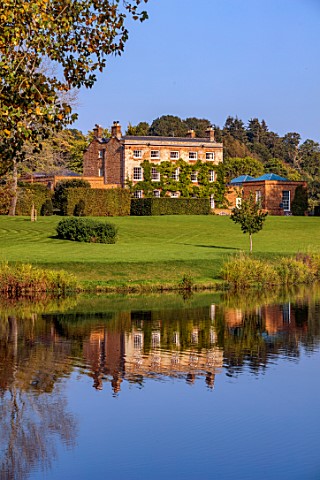 PRIORS_MARSTON_WARWICKSHIRE_VIEW_ACROSS_LAKE_TO_MANOR_HOUSE_SEPTEMBER_REFLECTED_REFLECTIONS