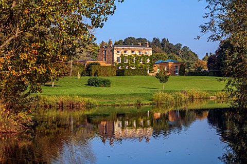 PRIORS_MARSTON_WARWICKSHIRE_VIEW_ACROSS_LAKE_TO_MANOR_HOUSE_SEPTEMBER_REFLECTED_REFLECTIONS