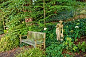 THE DOWER HOUSE, DERBYSHIRE: WOODLAND, STATUE, WOODEN BENCH, SEAT, HYDRANGEA ANNABELLE, CERCIDIPHYLLUM JAPONICUM, WOODS, SHADE, SHADY, GREEN, WHITE, FLOWERS