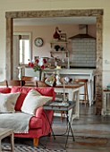 ASHBROOK HOUSE, NORTHAMPTONSHIRE: LIVING ROOM WITH PINK, RED SOFA AND KITCHEN