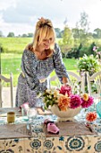 ASHBROOK HOUSE, NORTHAMPTONSHIRE: VANESSA KONIG ARRANGING FLOWERS ON THE DINING TABLE