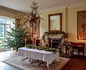 MARBURY HALL, SHROPSHIRE: DESIGNER SOFIE PATON-SMITH - DINING ROOM, CHRISTMAS TREE, FIREPLACE GARLAND OF HOPS, TABLE, CHAIRS, DECEMBER