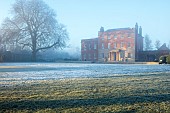MORTON HALL, WORCESTERSHIRE: THE HOUSE, LAWN IN DECEMBER, JANUARY, SNOW, FROST, WINTER, TREES
