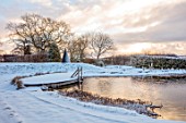 REDHILL LODGE, RUTLAND: DESIGNERS RICHARD AND SUSAN MOFFITT - NATURAL SWIMMING POOL, POND, HOUSE, SNOW, WINTER, JANUARY, WOODEN DECK, DECKING, SCULPTURE BY JAMES PARKER