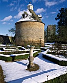 SNOW BLANKETS THE PIGEON HOUSE AND ROSE PARTERRE AT ROUSHAM PARK  OXFORDSHIRE