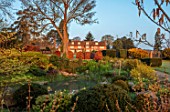 LOWER BOWDEN MANOR, BERKSHIRE: SPRING, APRIL, SUNRISE, MORNING, ENGLISH, COUNTRY, GARDEN - YEW, POND, CLIPPED BEECH